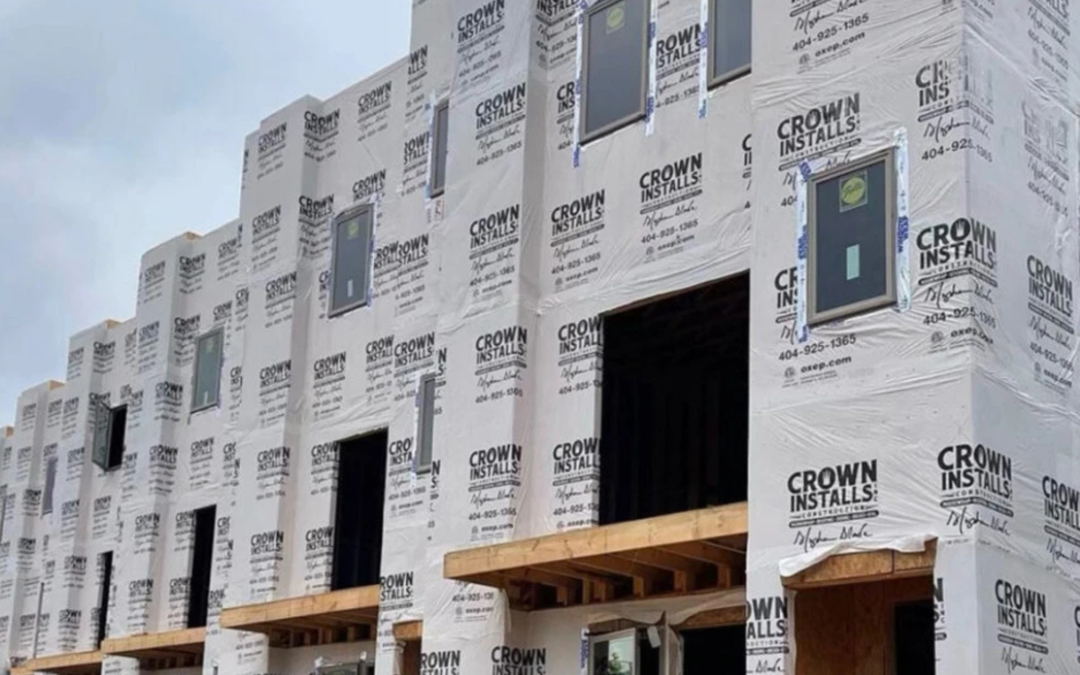 Crown Installs Housewrap on building